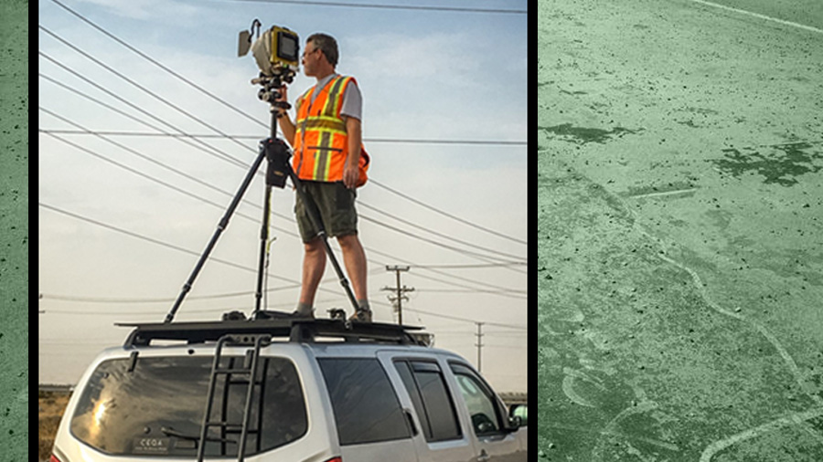 photo of Stephen Schafer on top of a car with a camera on a tripod