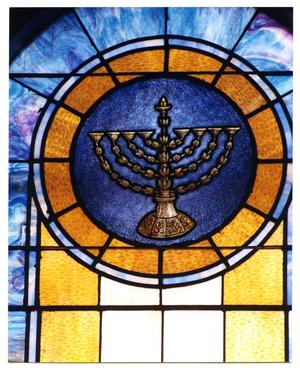 stained glass window showing a menorah