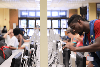 man at the student computer workstation