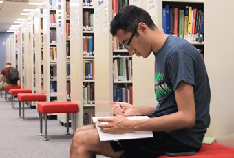 man sitting with an open book in his lap