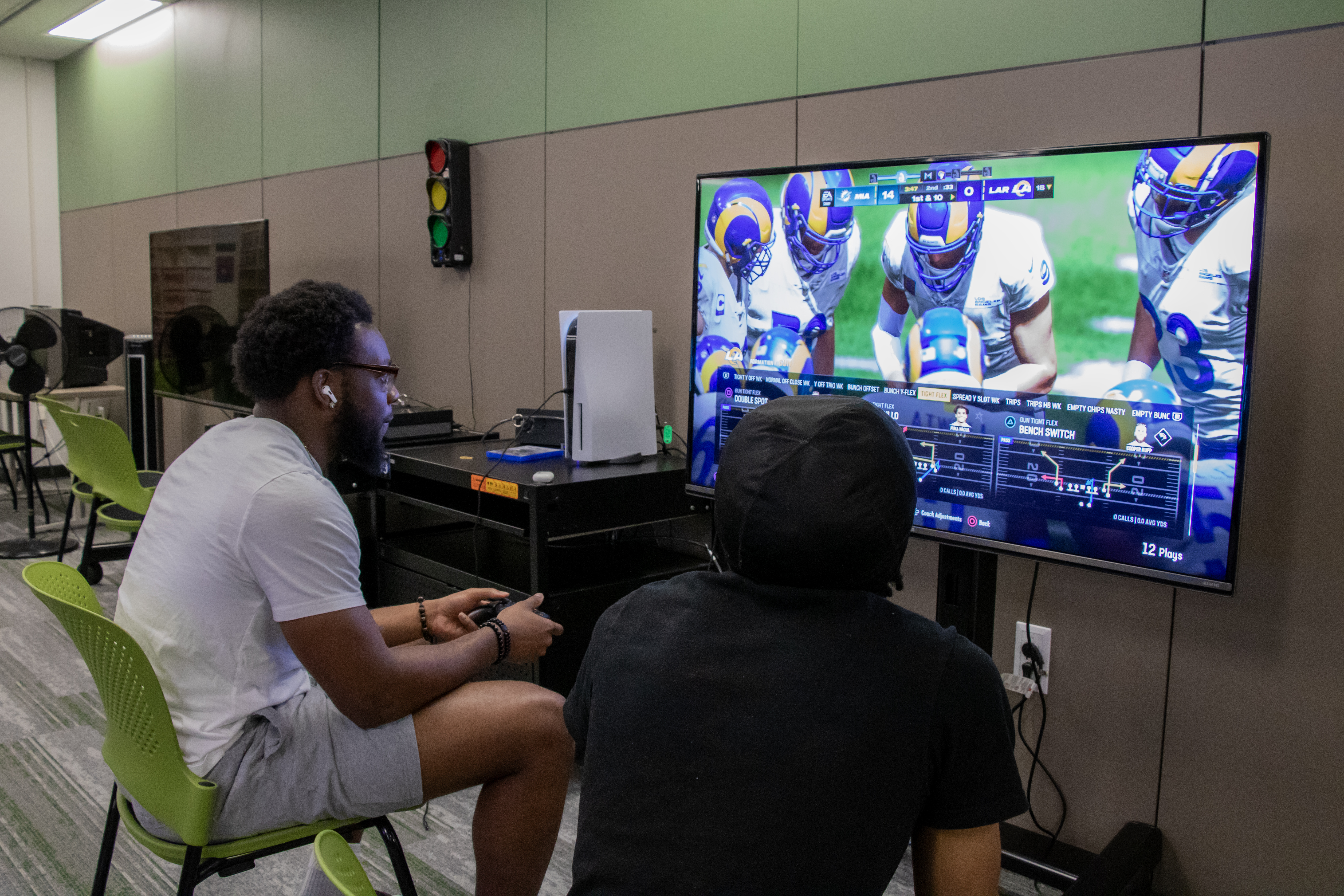 Console game station with two players playing a game